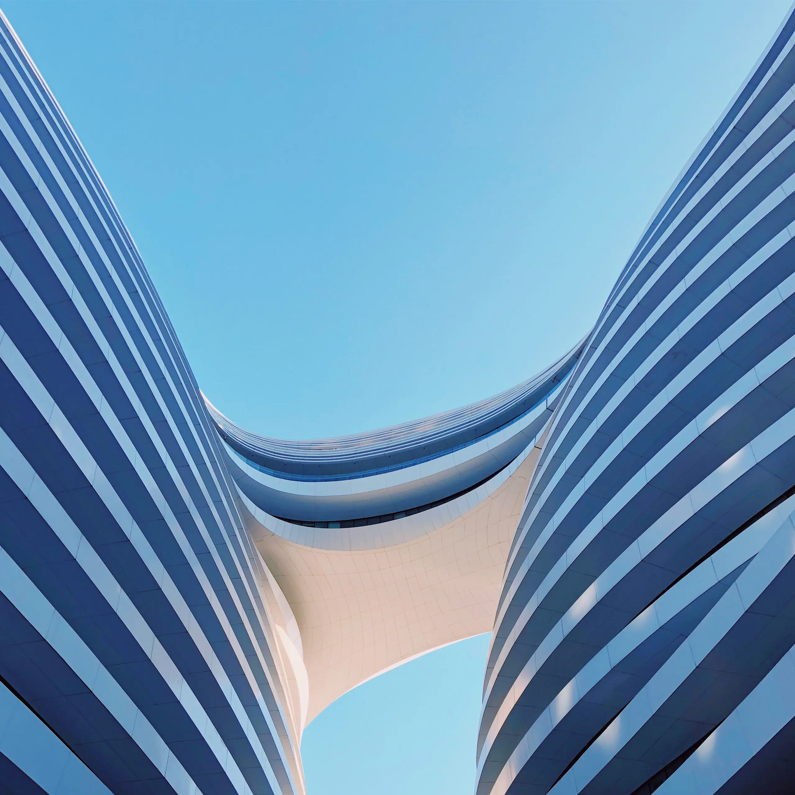 Curved twin towers against a blue sky